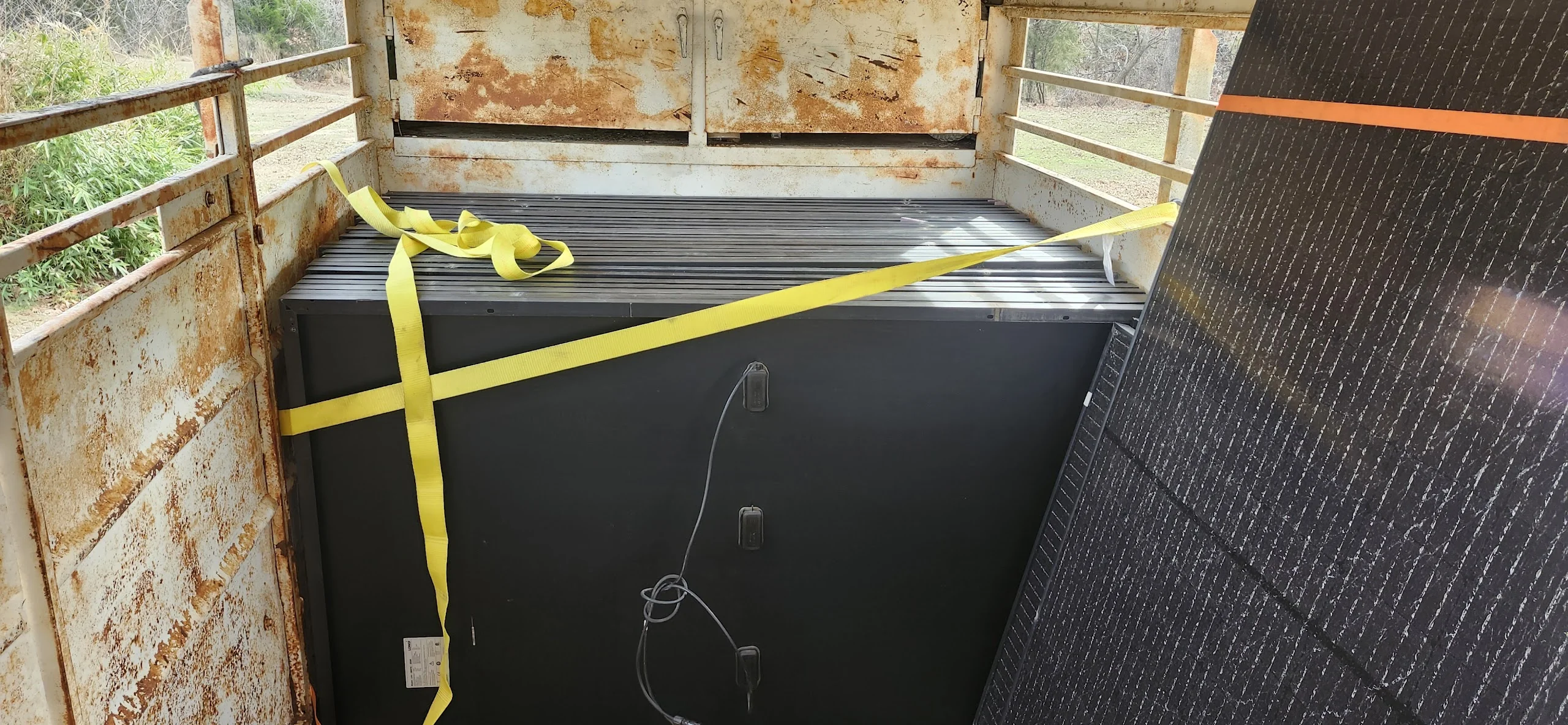 40 used solar panels stacked on a trailer