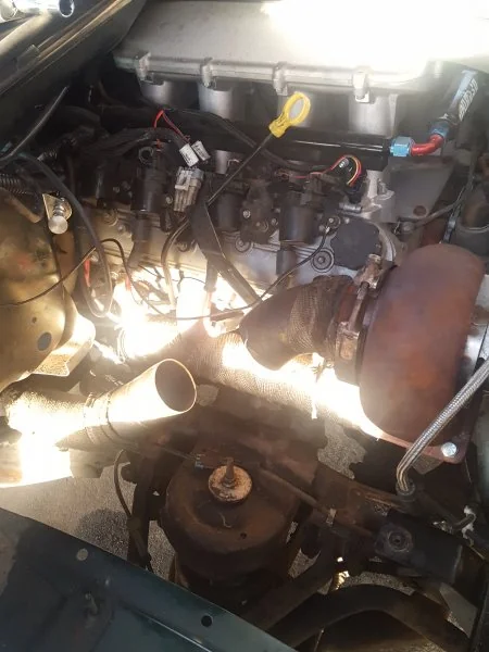 After some strategic cuts, I was able to get the downpipe routed in the proper direction.