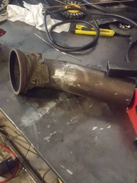 A section welding to the output-side of the turbo.
