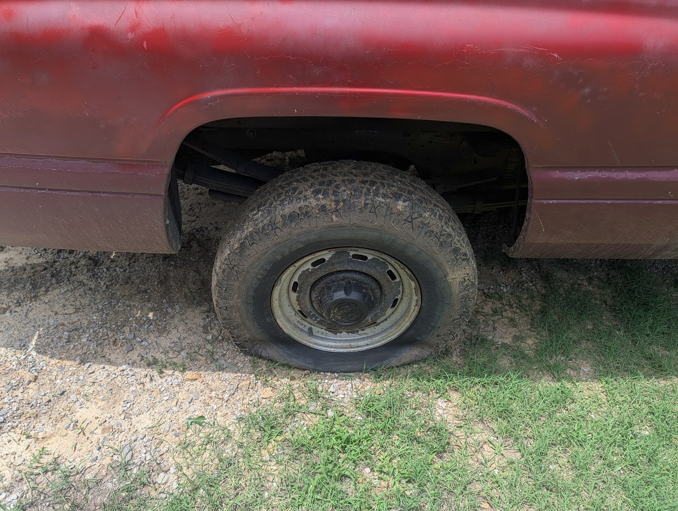 Flat tire on the trailer out in the field