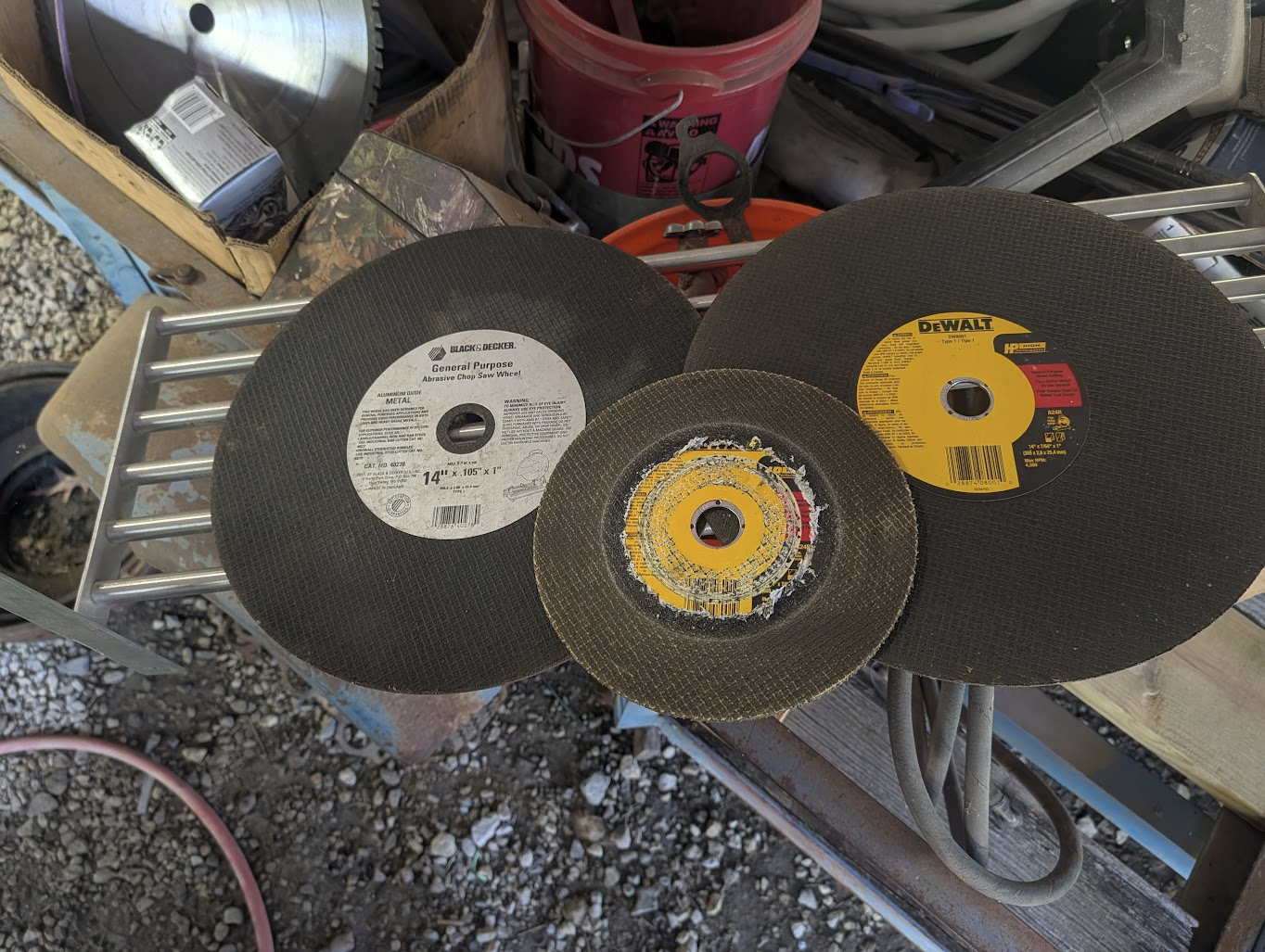 Worn-down abrasive cutoff discs from cutting the pipe