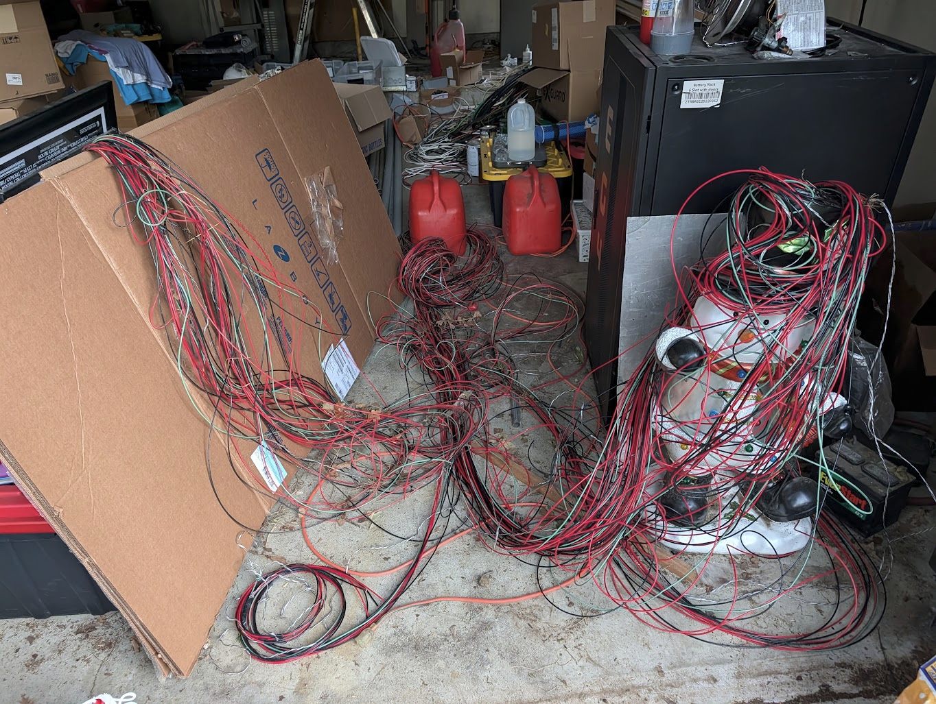 The same cable hauled back out of the garage in a pile