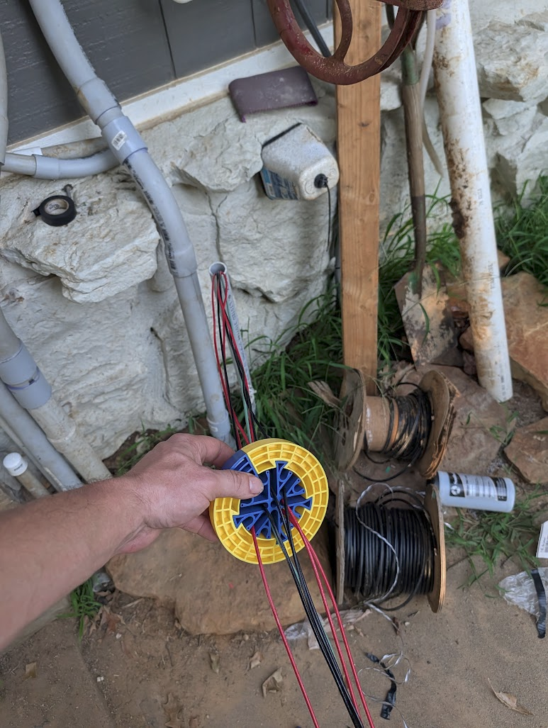 Feeding conductors into the conduit at the top of the run