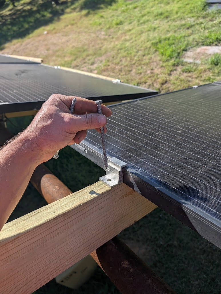 Smaller fastener driven through an end clamp into the 2x6