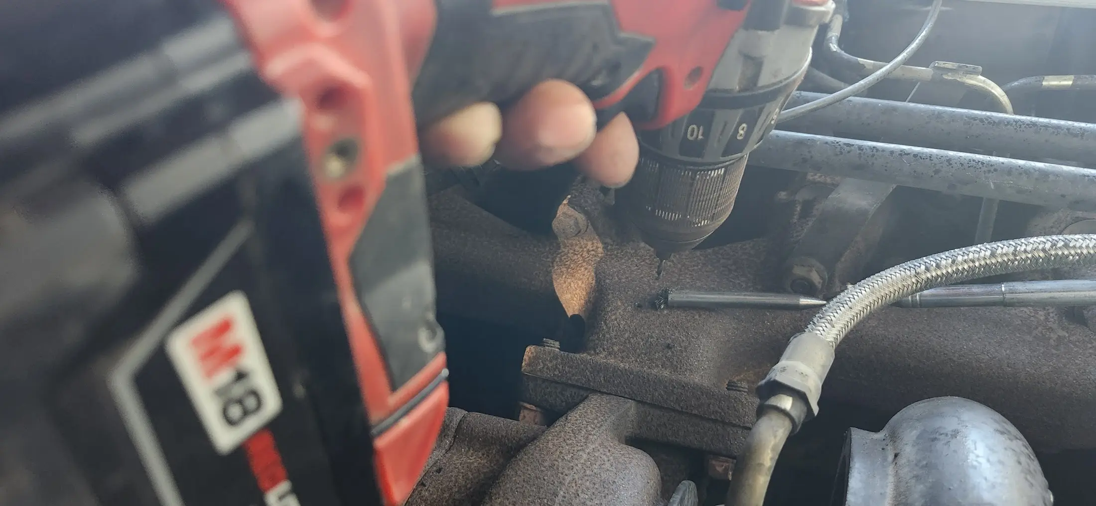 Picturing showing me drilling the hole. Pen magnet is catching shavings.