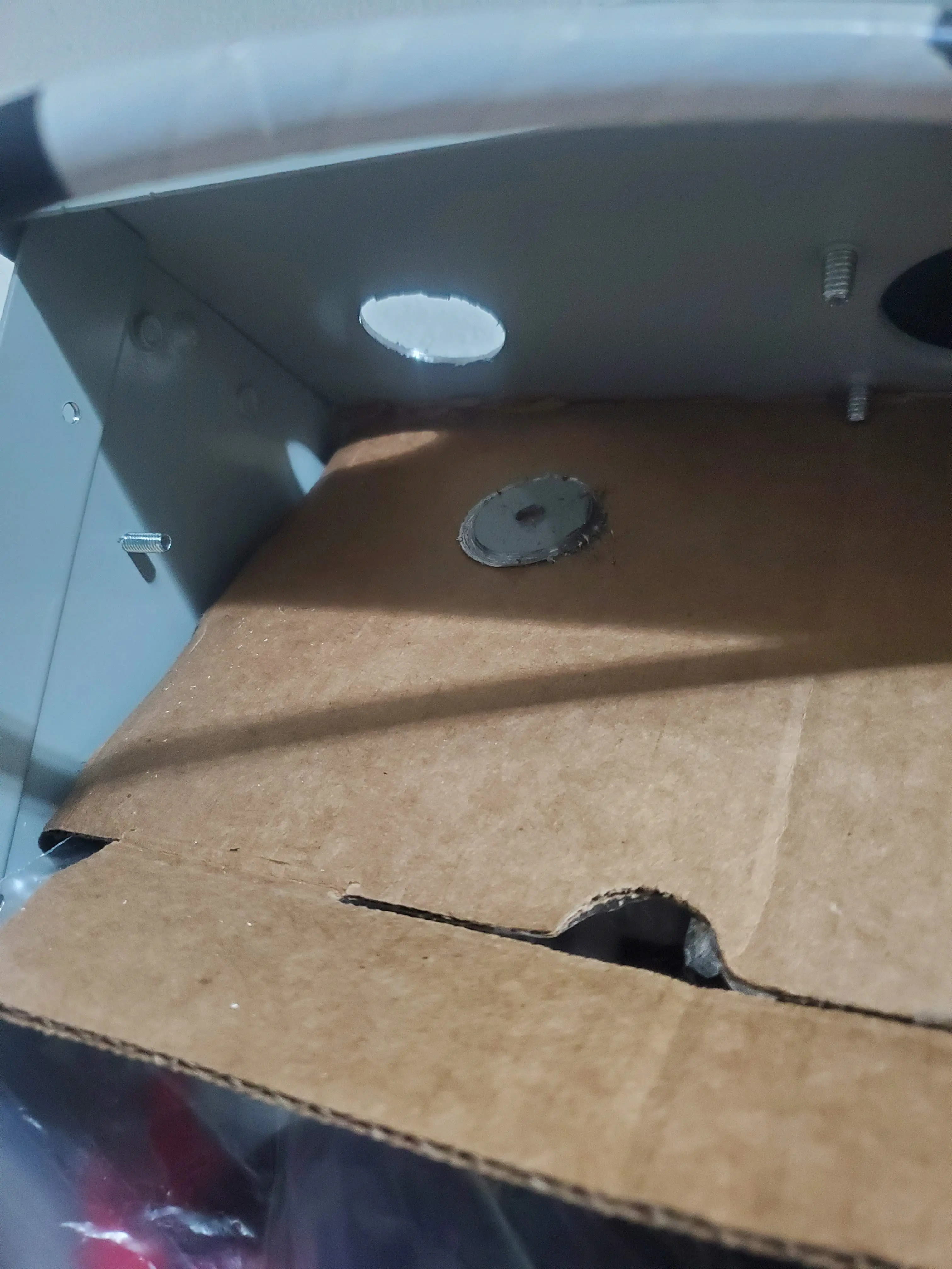 Piece of cardboard to deflect metal shavings